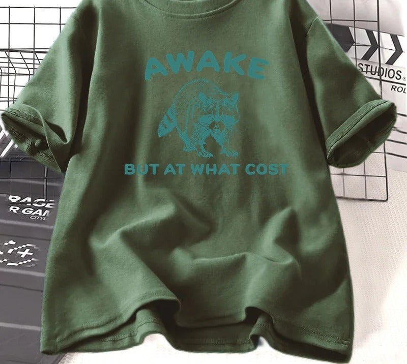 Army green cotton tee printed with a teal engraved raccoon and the words awake but at what cost