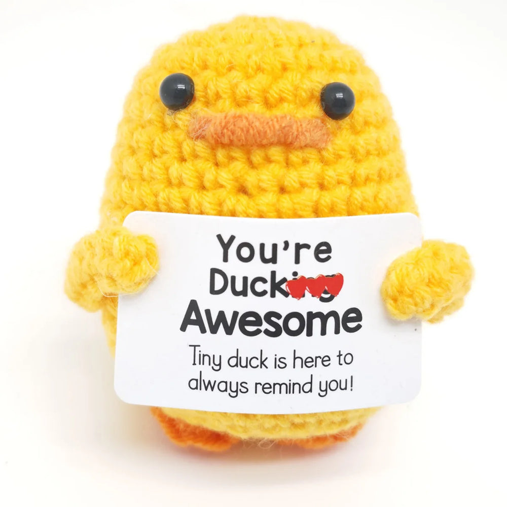 Crochet positive affirmation doll holding an encouragement card