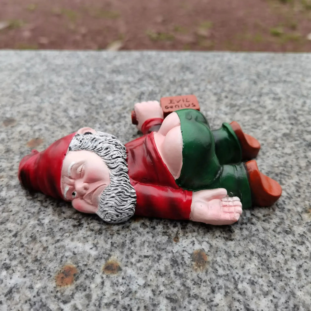 Medium Red, the red-coated gnome lying face down on stone
