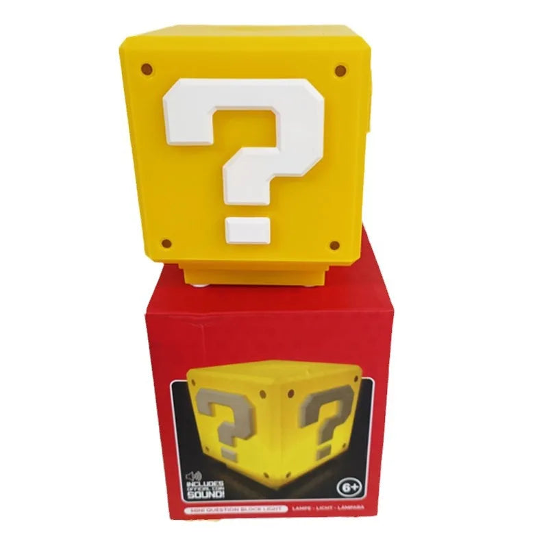 The unlit yellow cube standing on its red retail carton, which prints includes sound and an ages six plus mark