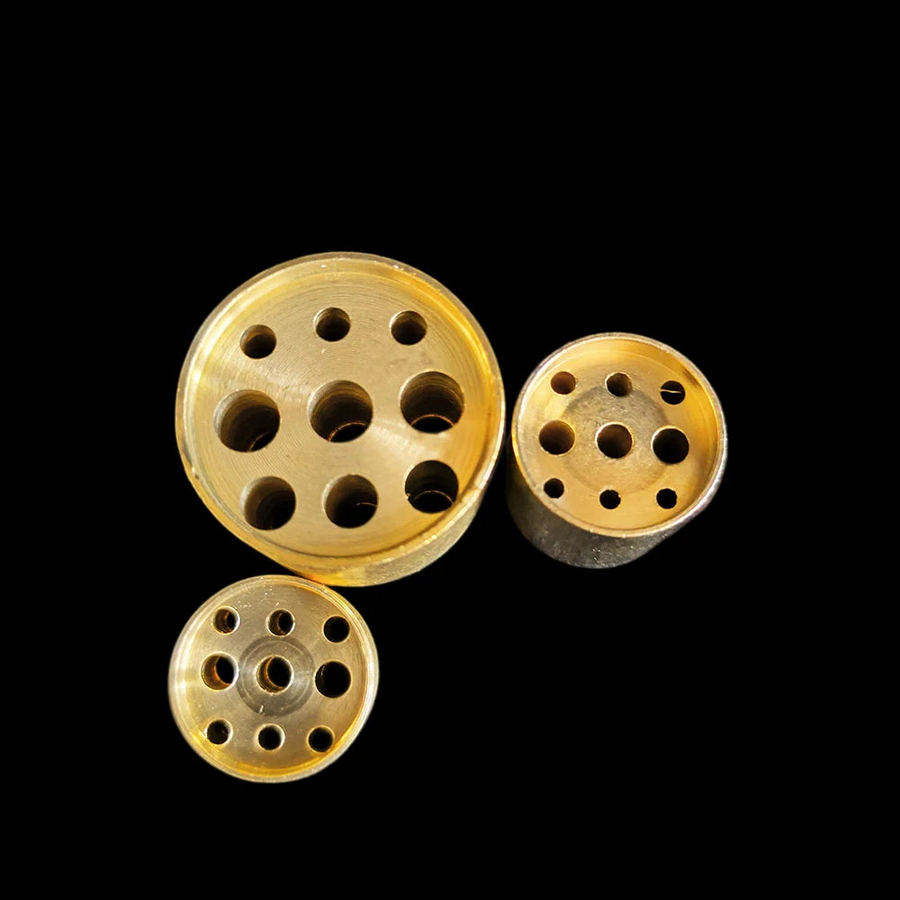 Looking down at the drilled tops of three of the holders, showing the different hole diameters
