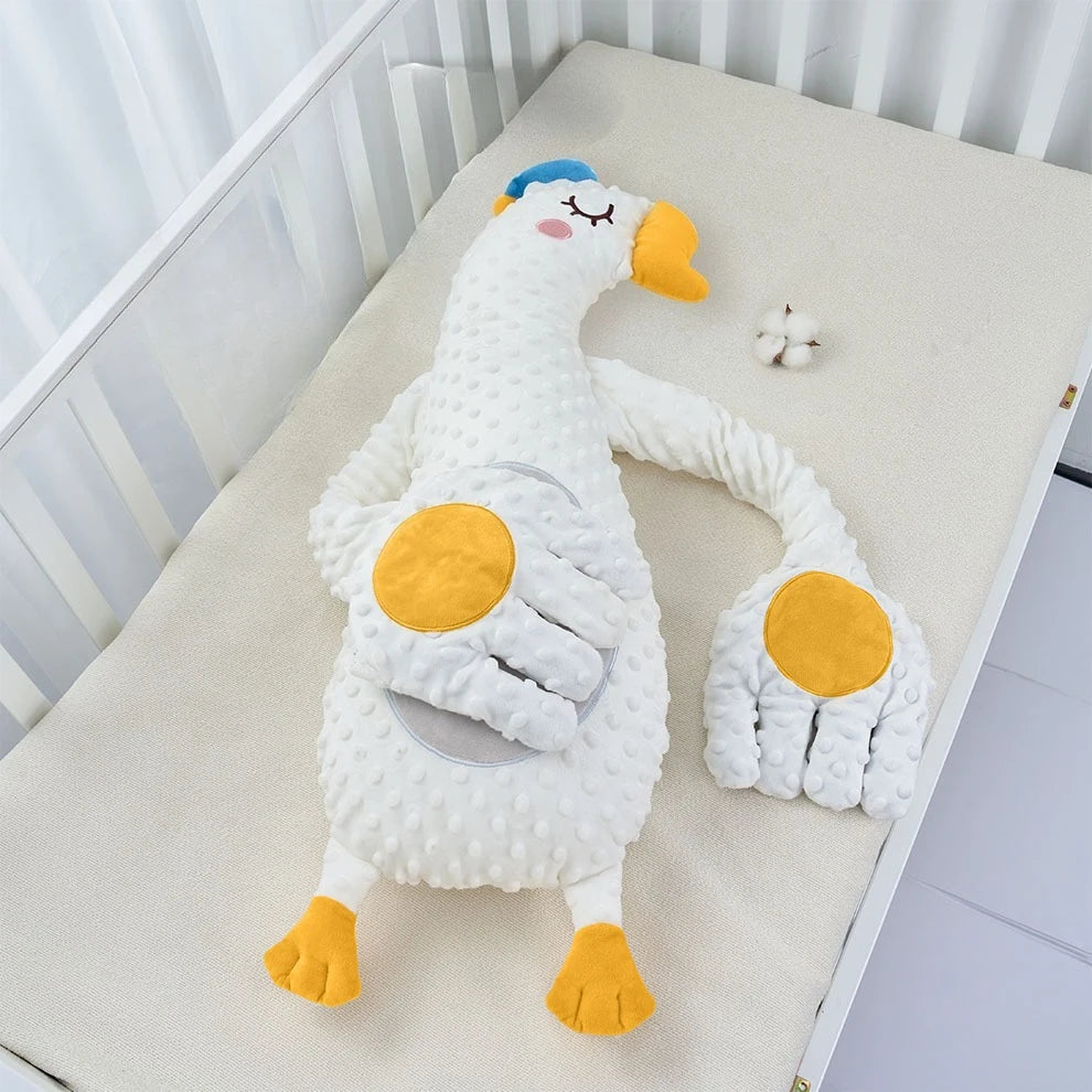 The white goose design with a blue cap and yellow feet, lying on a cot mattress