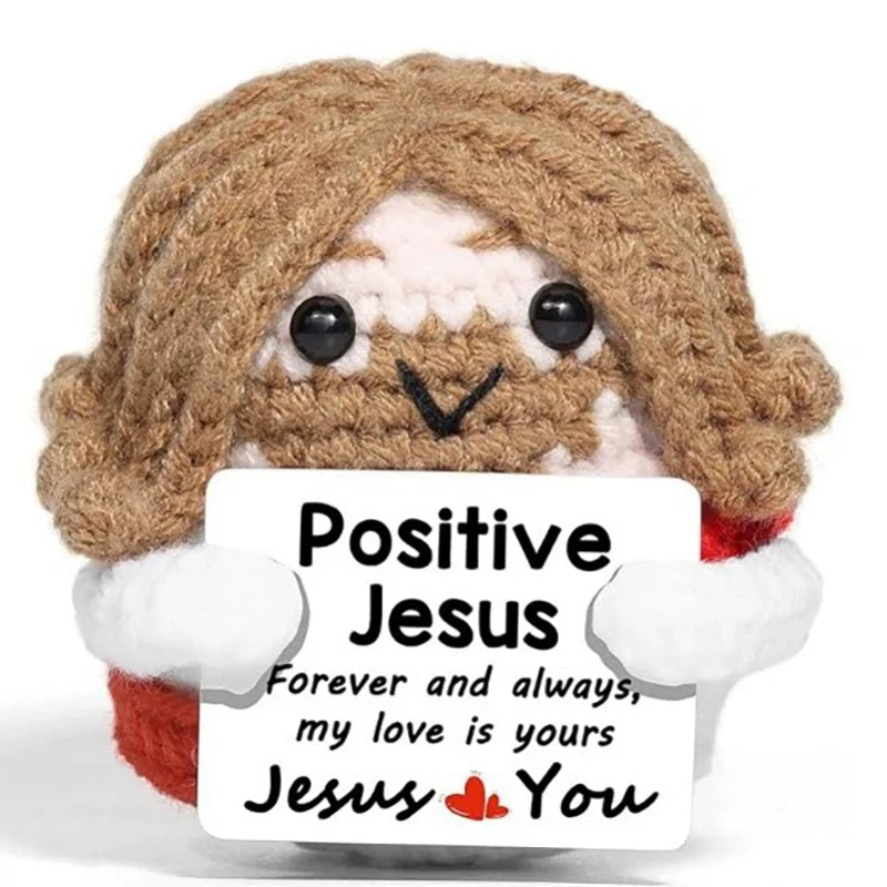 Crochet positive affirmation doll holding an encouragement card