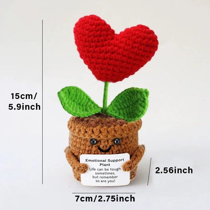 Crochet positive affirmation doll holding an encouragement card