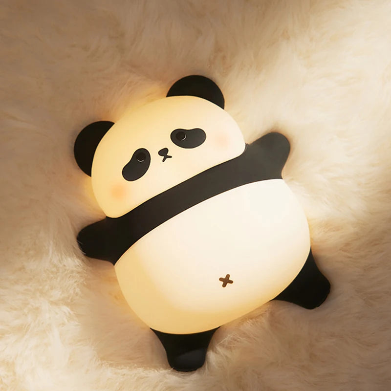 The spread-out panda night light lying on a fluffy cream rug, glowing warm through its white belly