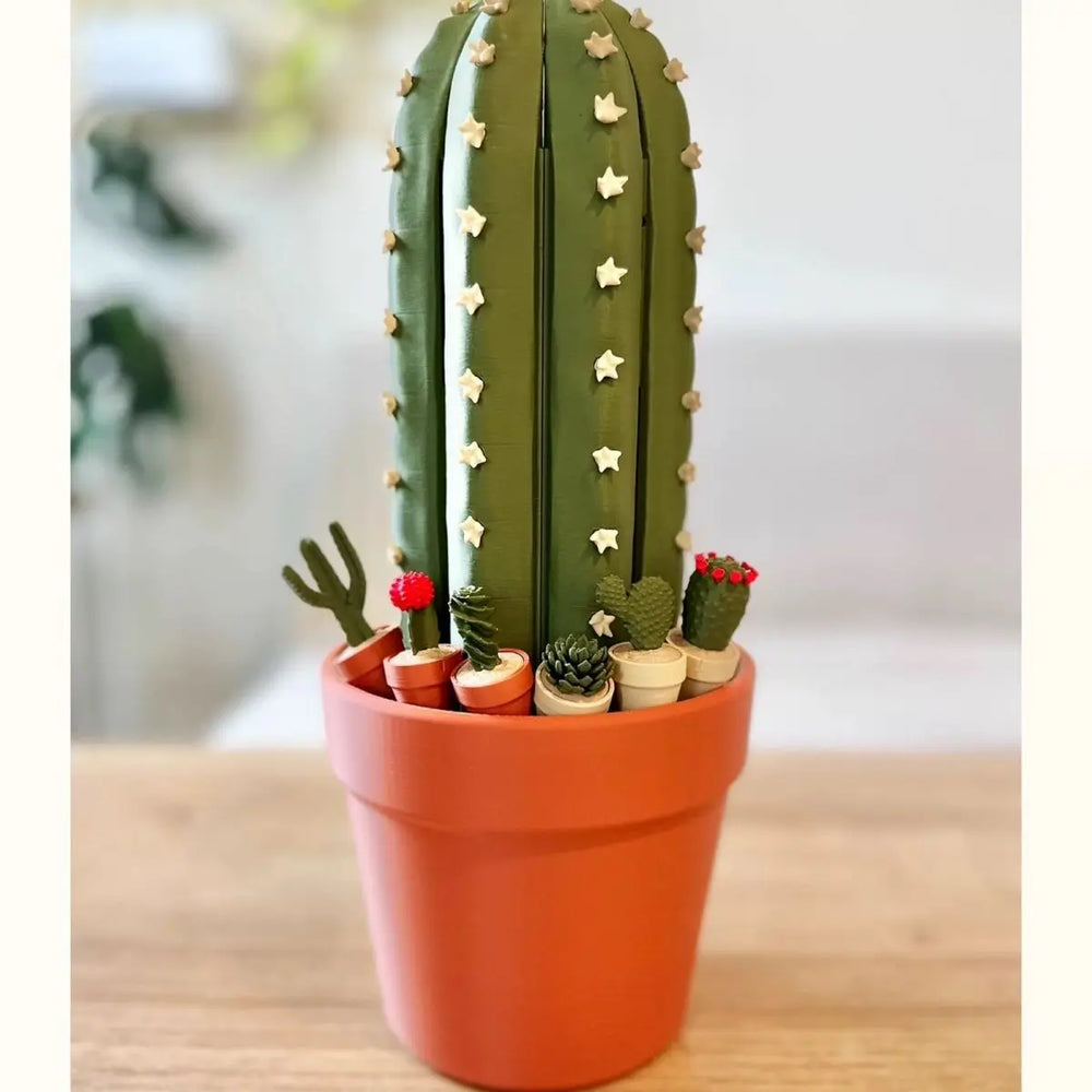 The set closed and stood upright in a terracotta plant pot, reading as one tall ribbed cactus