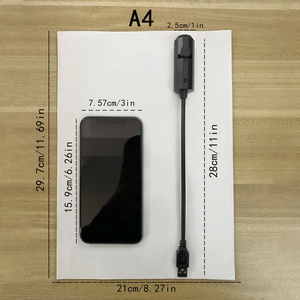 The lamp laid on an A4 sheet beside a phone for scale, arm 28 cm long