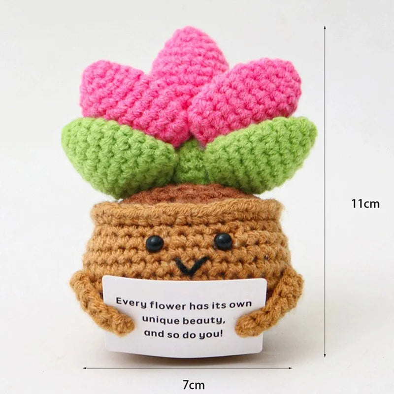 Crochet positive affirmation doll holding an encouragement card
