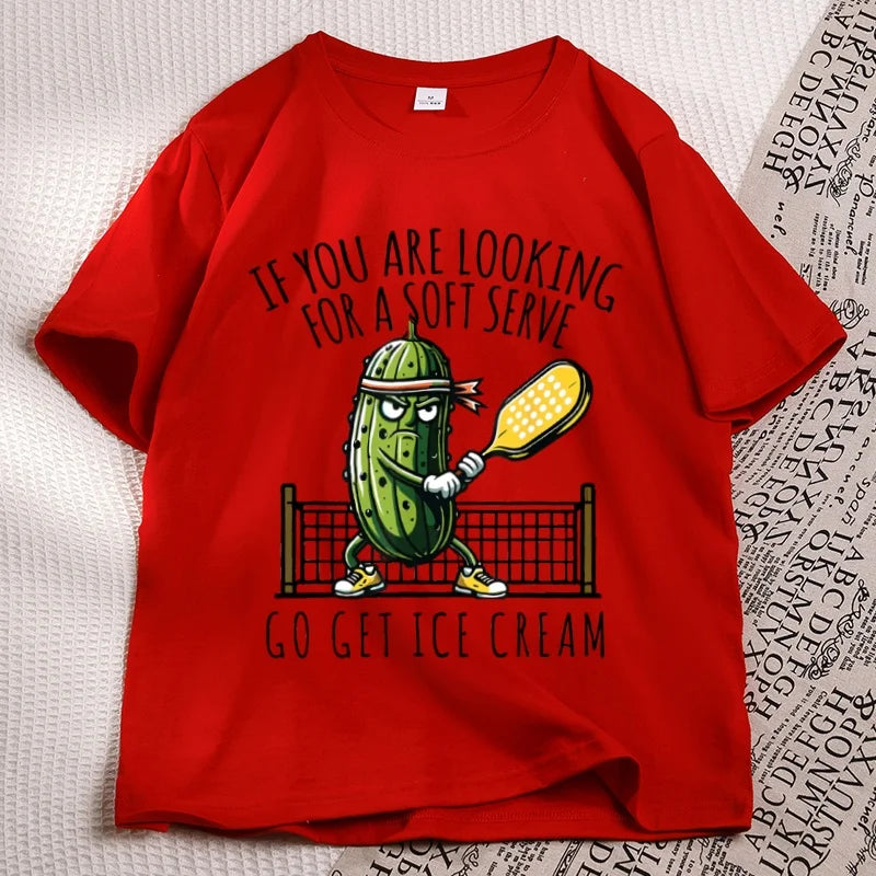 Red pickleball tee laid flat, cartoon pickle with a paddle printed on the chest