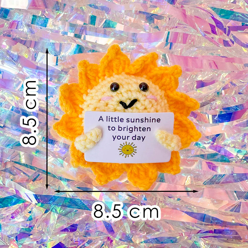 Crochet positive affirmation doll holding an encouragement card