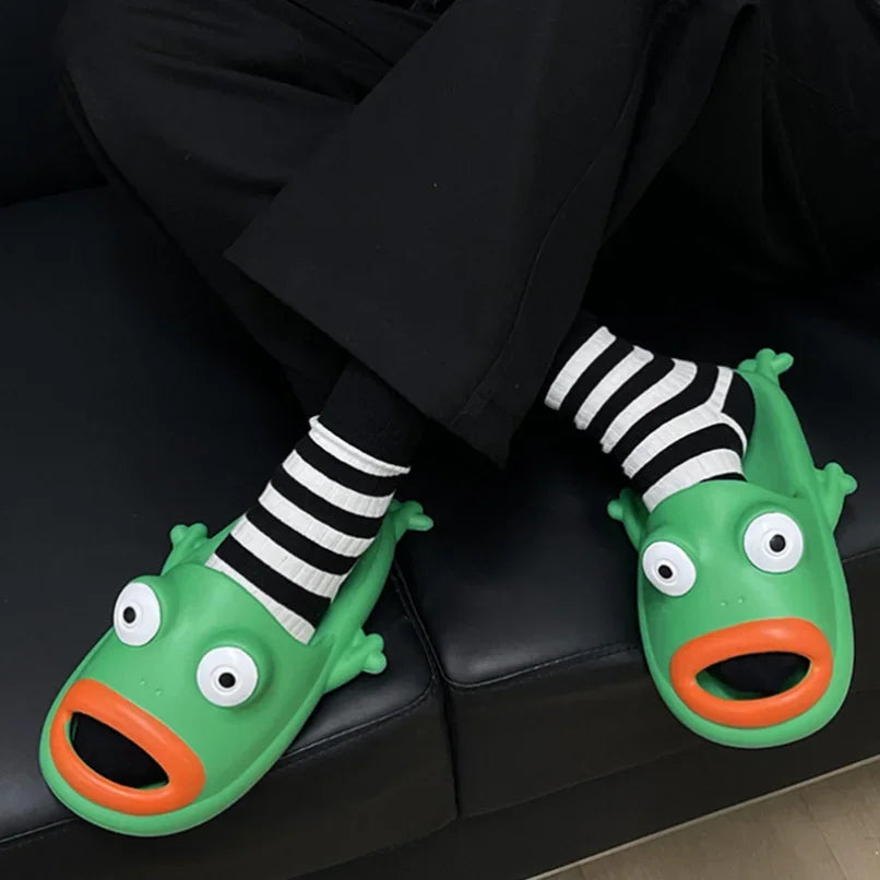 Green frog slides worn by a person sitting on a couch