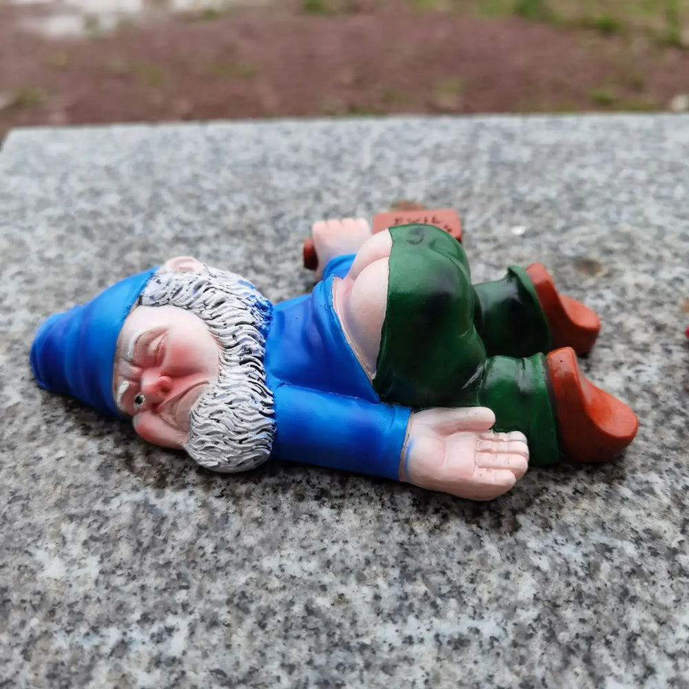 Medium Blue, the blue-coated gnome lying face down on stone