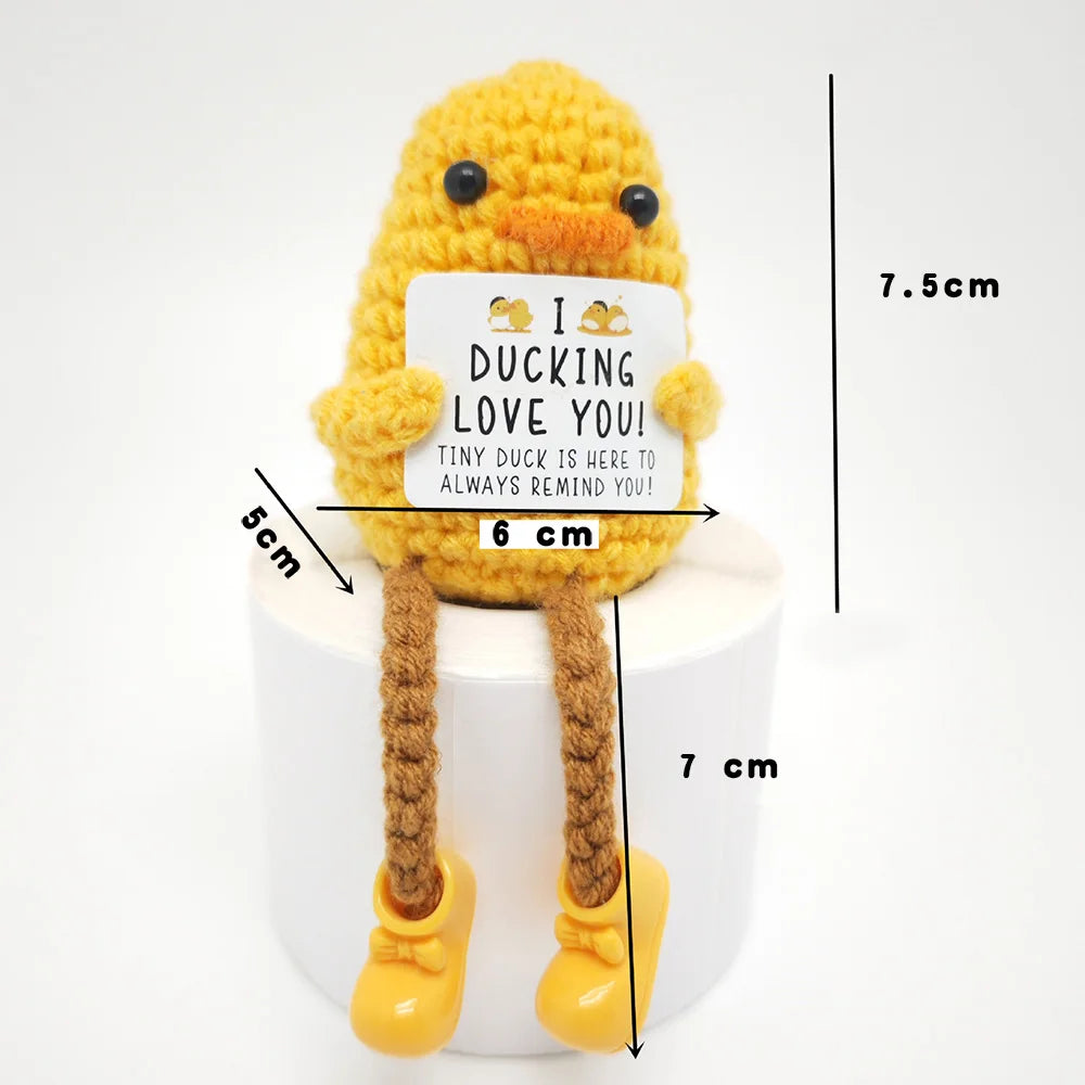 Crochet positive affirmation doll holding an encouragement card