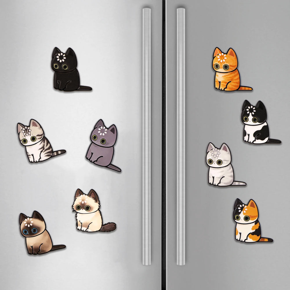 Several of the cat magnets stuck across a stainless steel fridge door