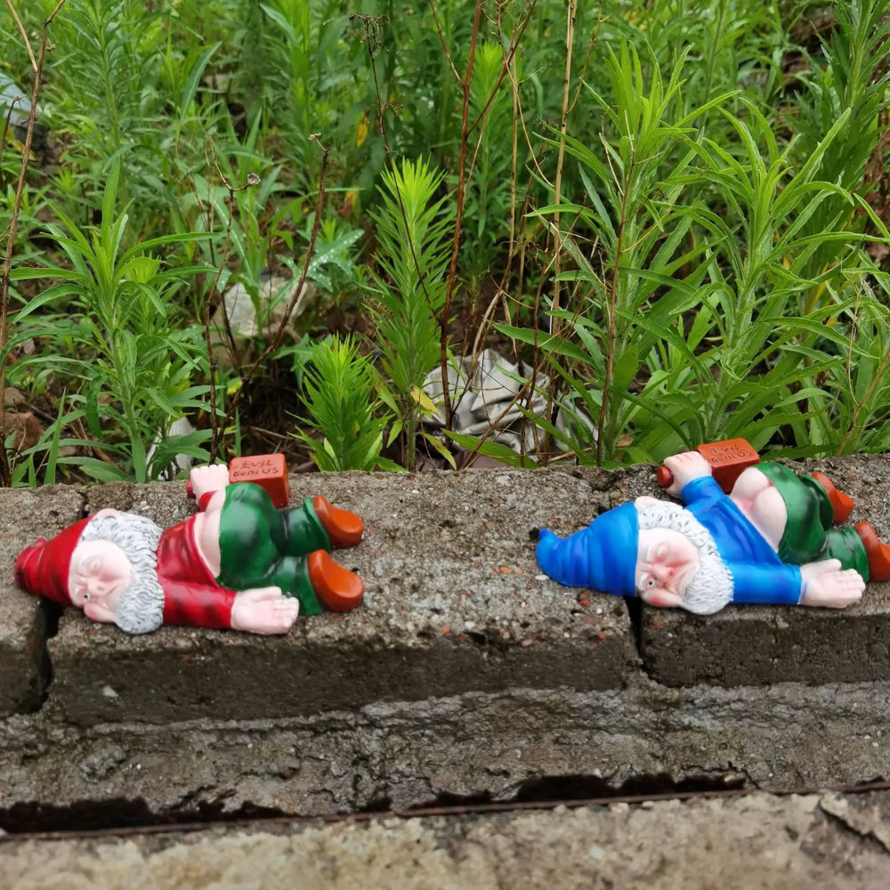 Three of the gnomes face down in grass