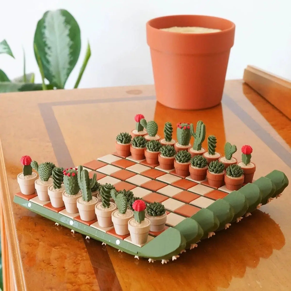 Cactus chess set on a glossy wooden table, pieces set out as miniature potted cacti on cream and terracotta squares