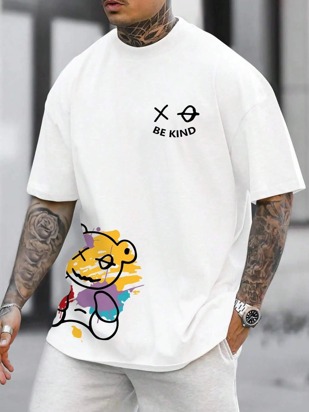 White cotton tee printed with a graffiti bear and the words BE KIND