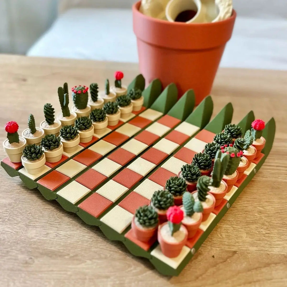 Angled view of the open board showing green cactus-paddle edges and both rows of potted plant pieces