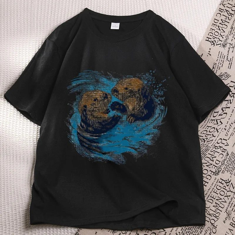 Black sea otter tee laid flat, two otters printed on the chest