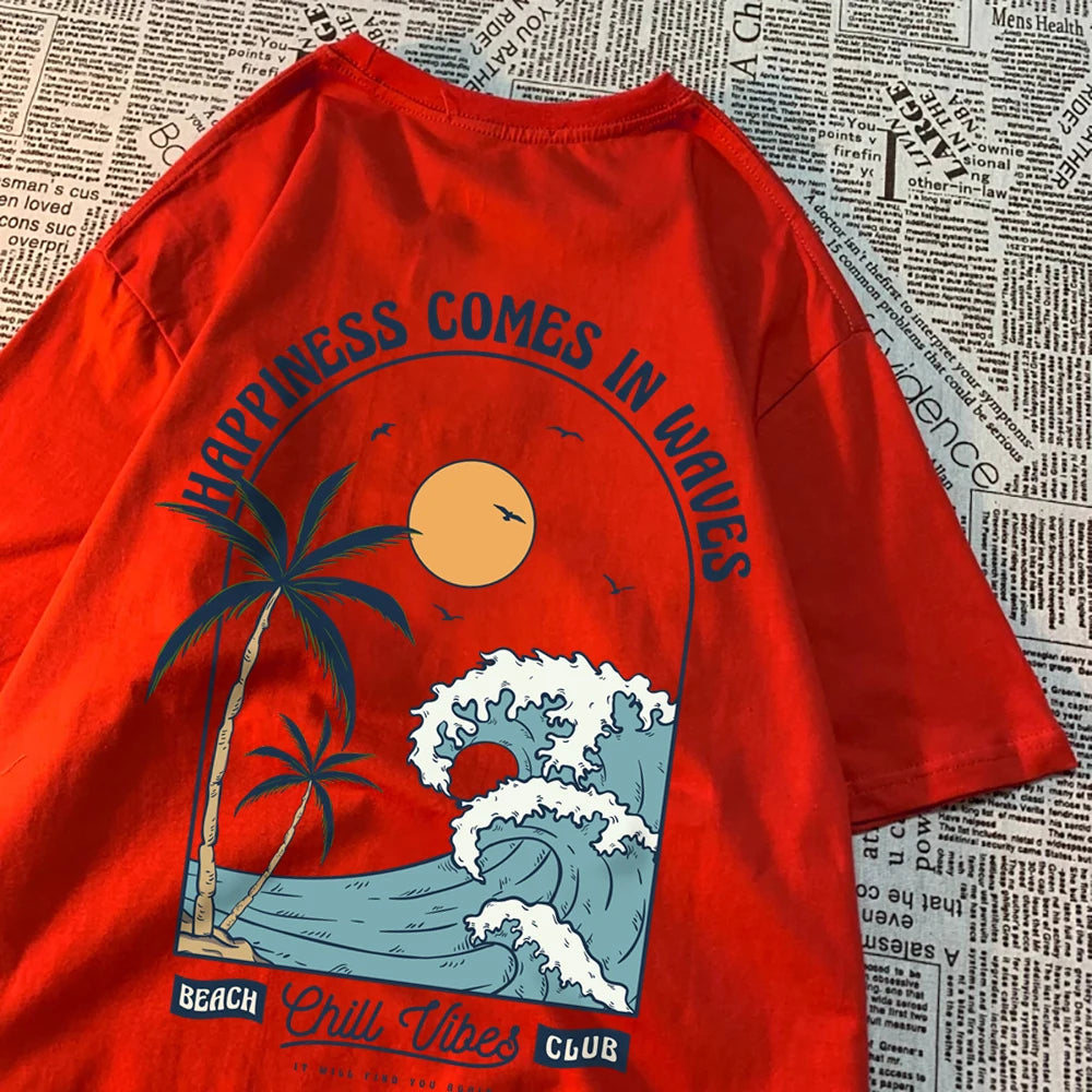 Red cotton tee with a large back print of a breaking wave, palm trees and a low sun, under the arched words Happiness Comes In Waves