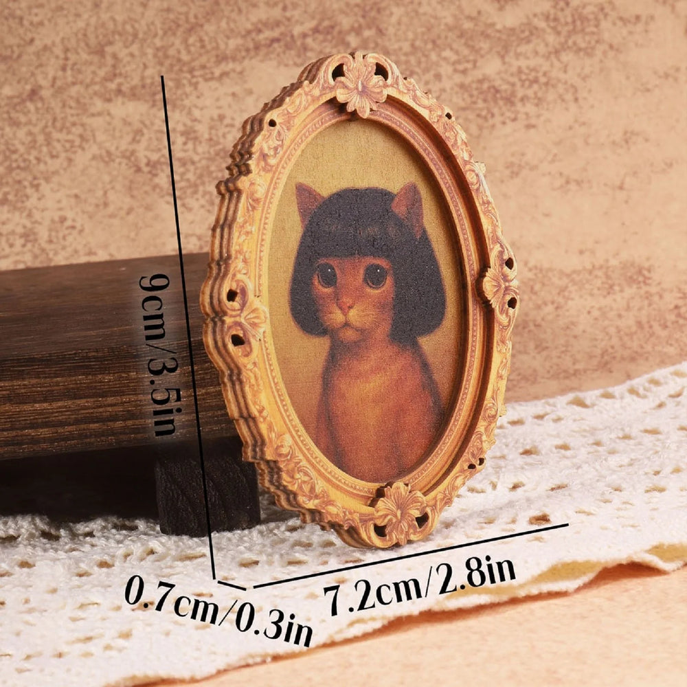 The cat version of the framed magnet, a ginger cat in a black bob wig