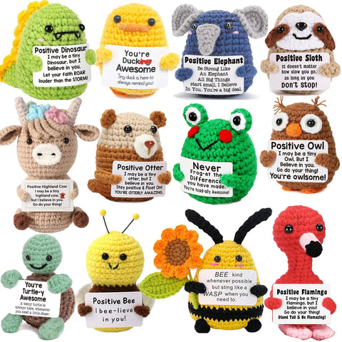 Crochet positive affirmation doll holding an encouragement card