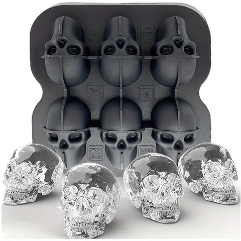 The six cavity skull tray with four clear skull ice cubes turned out in front of it