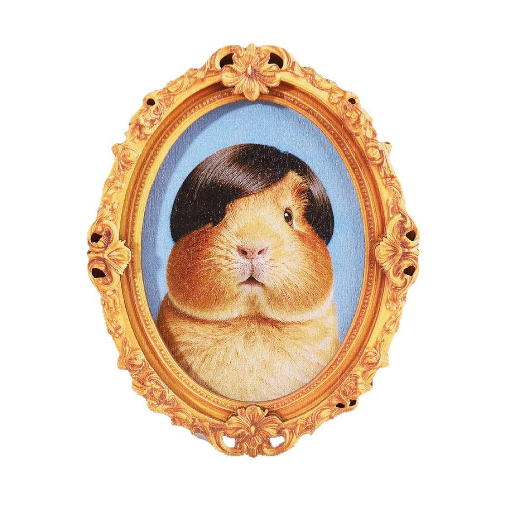 Gold framed oval magnet holding a painted portrait of a guinea pig in a dark bob wig