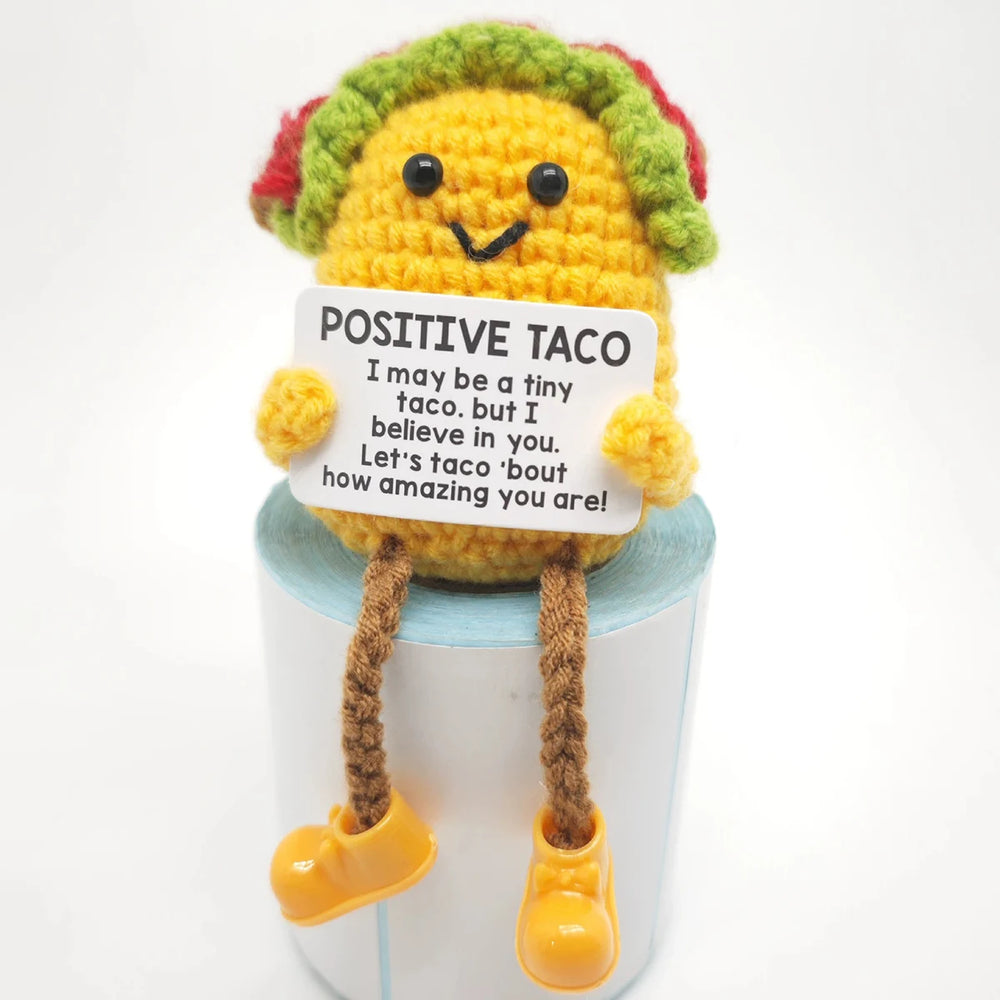 Crochet positive affirmation doll holding an encouragement card