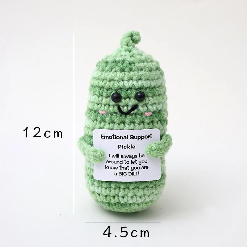 Crochet positive affirmation doll holding an encouragement card