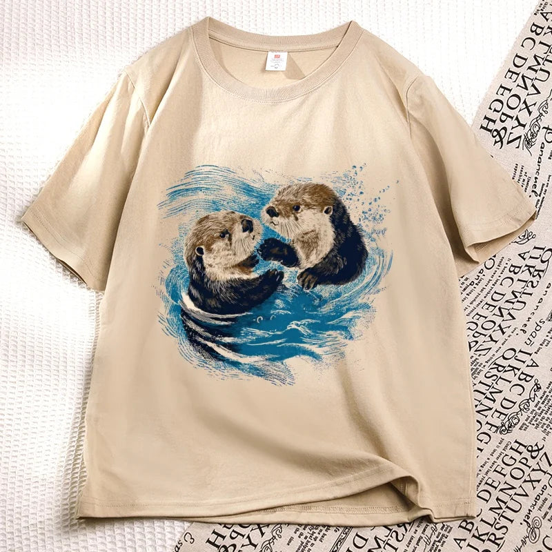 Khaki sea otter tee laid flat, two otters printed on the chest
