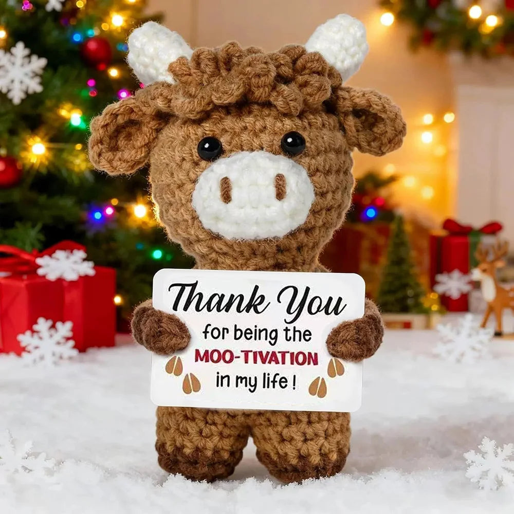 Crochet positive affirmation doll holding an encouragement card
