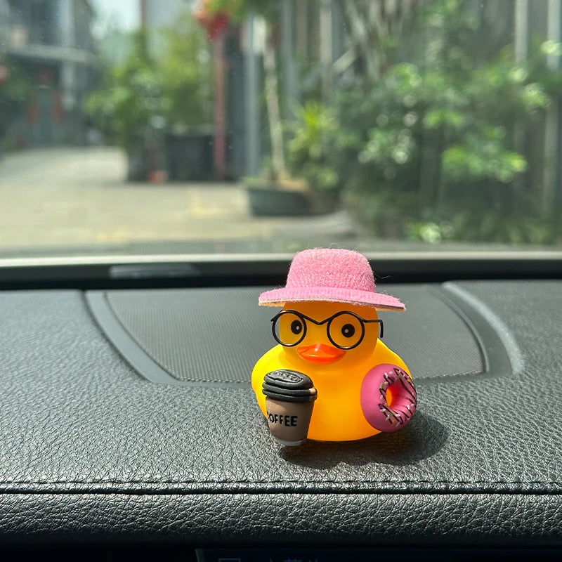 The pink-hatted duck sitting on a car dashboard