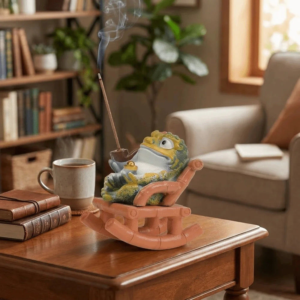 The incense holder on a side table beside books and a mug