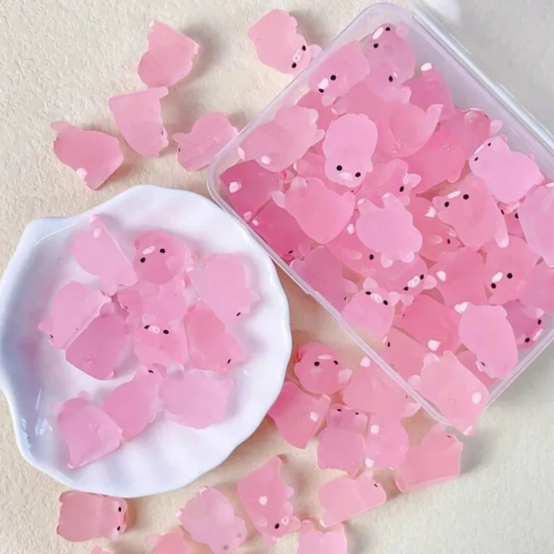 Pigs in their clear storage box beside a small dish