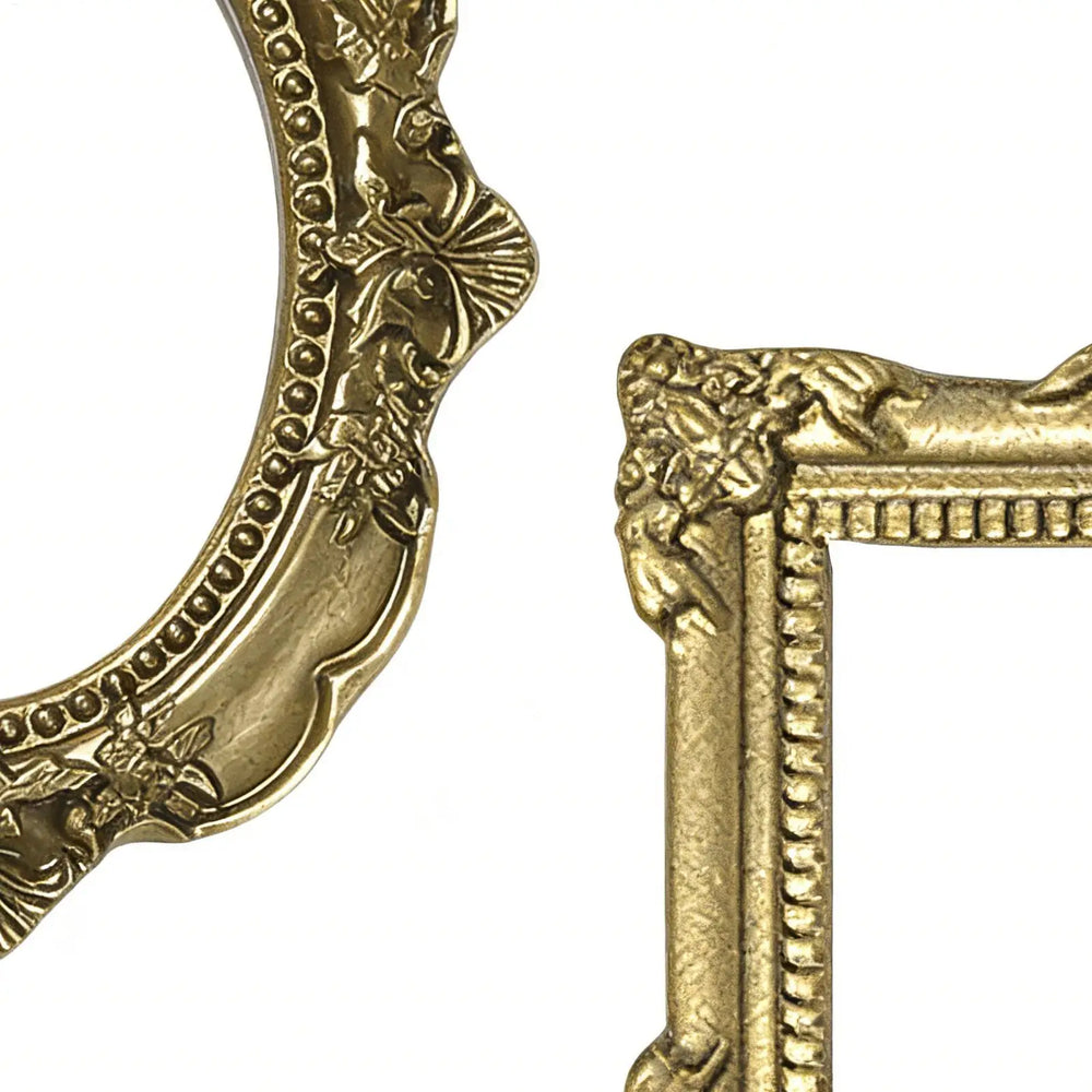 Close view of the moulded scrollwork and beaded edge on one gold frame