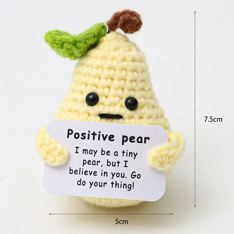 Crochet positive affirmation doll holding an encouragement card