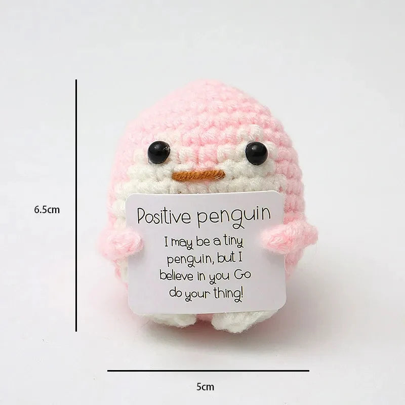 Crochet positive affirmation doll holding an encouragement card