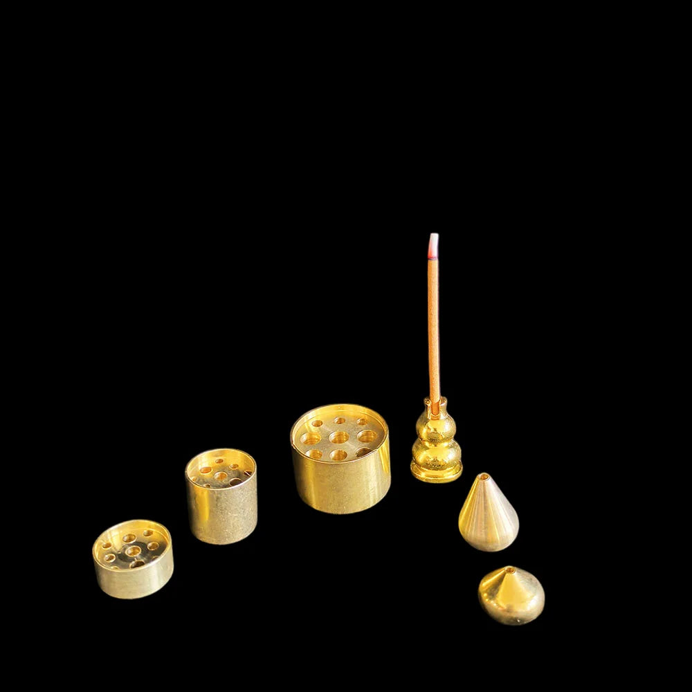 The full range on a black background: two cones, two drilled barrels, a drilled disc and a gourd post, with one lit stick. Only one holder is included per order