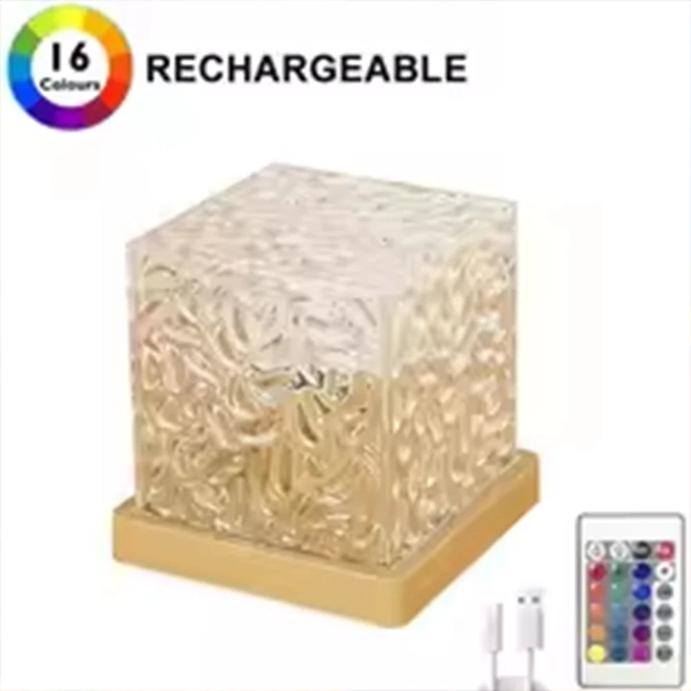Clear rippled acrylic cube lamp on a wood-tone base, with its remote and USB cable