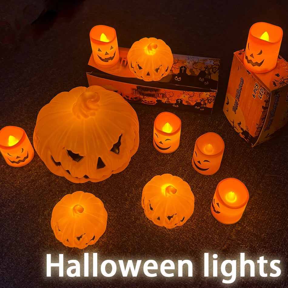 A group of lit pumpkin LED lanterns and tealights in the dark