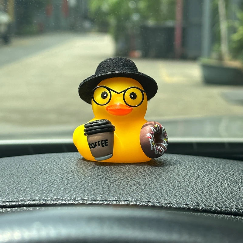 Close view of the black-hatted duck with its coffee cup and donut