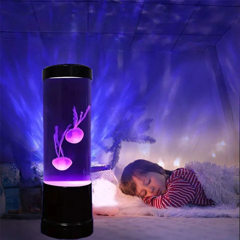 Jellyfish lamp glowing purple on a bedside table, colour washing across the wall behind it