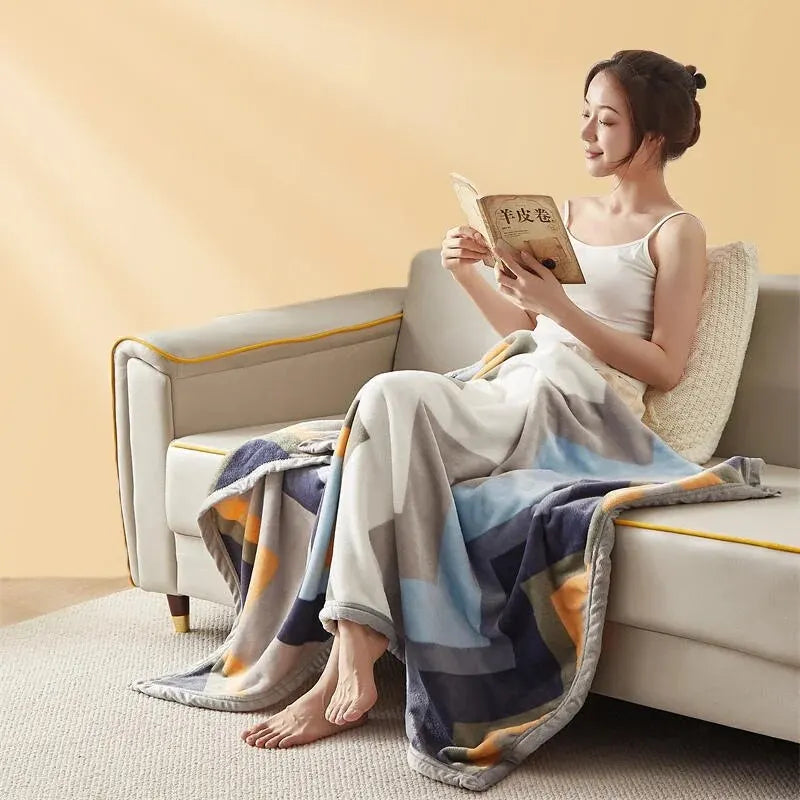 The chevron blanket draped over a seated person, showing its full length