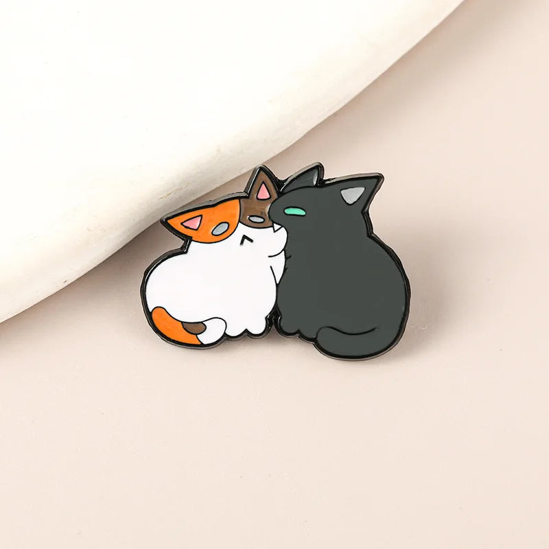 Broche de gato mordiendo a otro gato