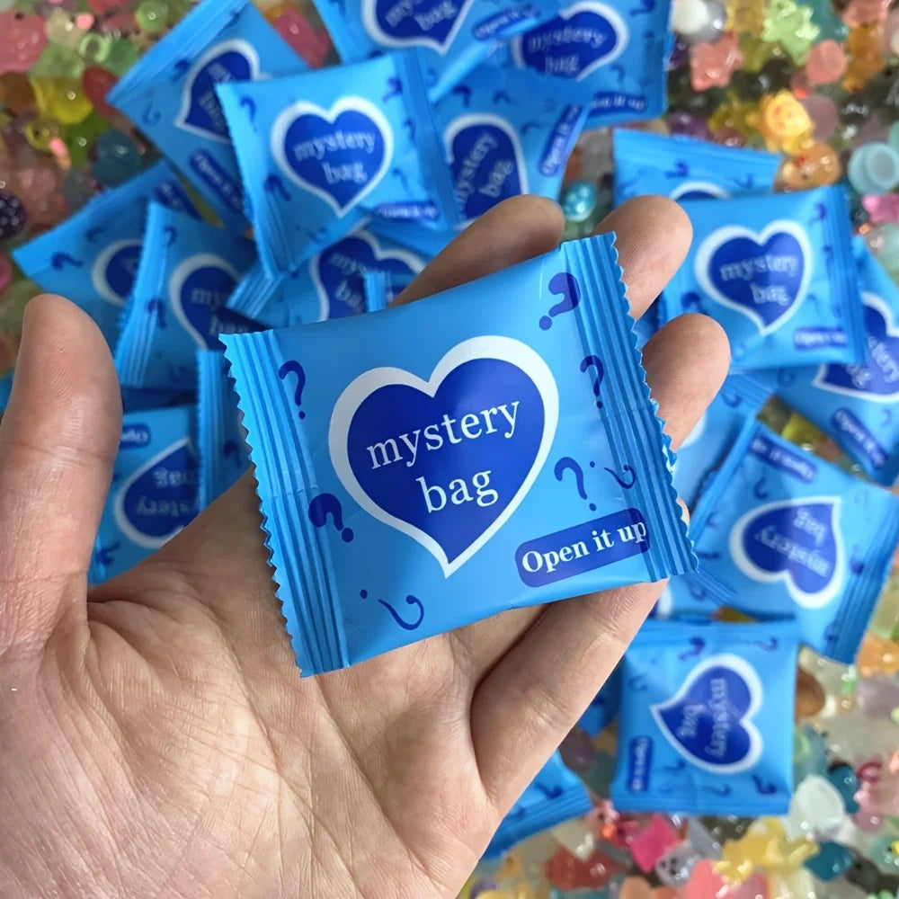 Close-up of the sealed blue foil mystery bags held in a hand