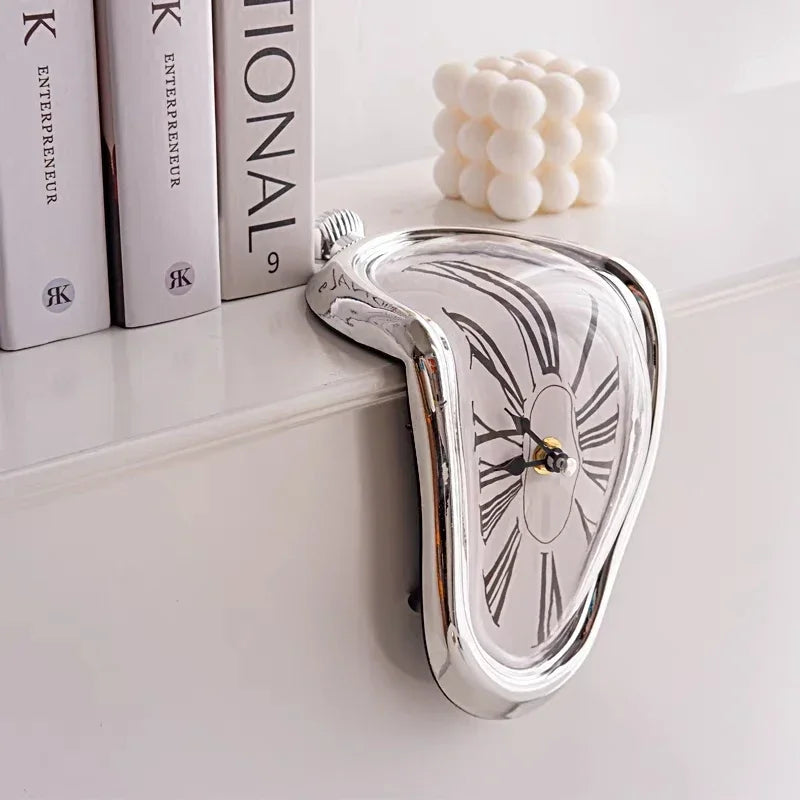 Mirrored silver melting clock hanging over a shelf beside books