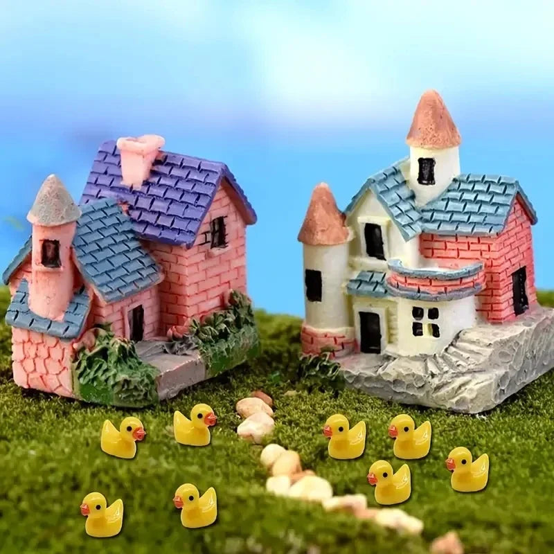 Ducks arranged on moss beside miniature houses - the houses are not included