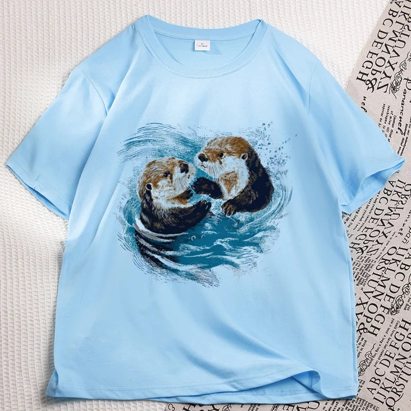 Sky blue sea otter tee laid flat, two otters printed on the chest