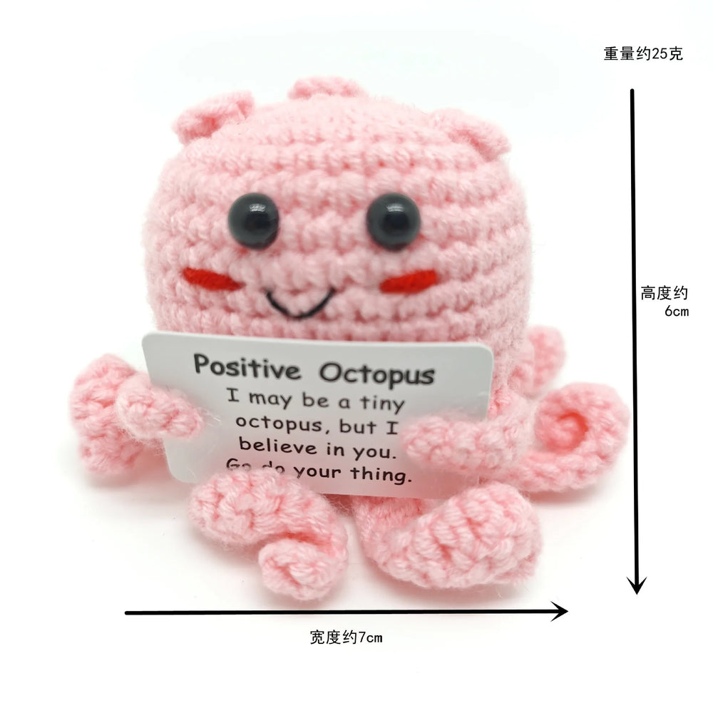 Crochet positive affirmation doll holding an encouragement card